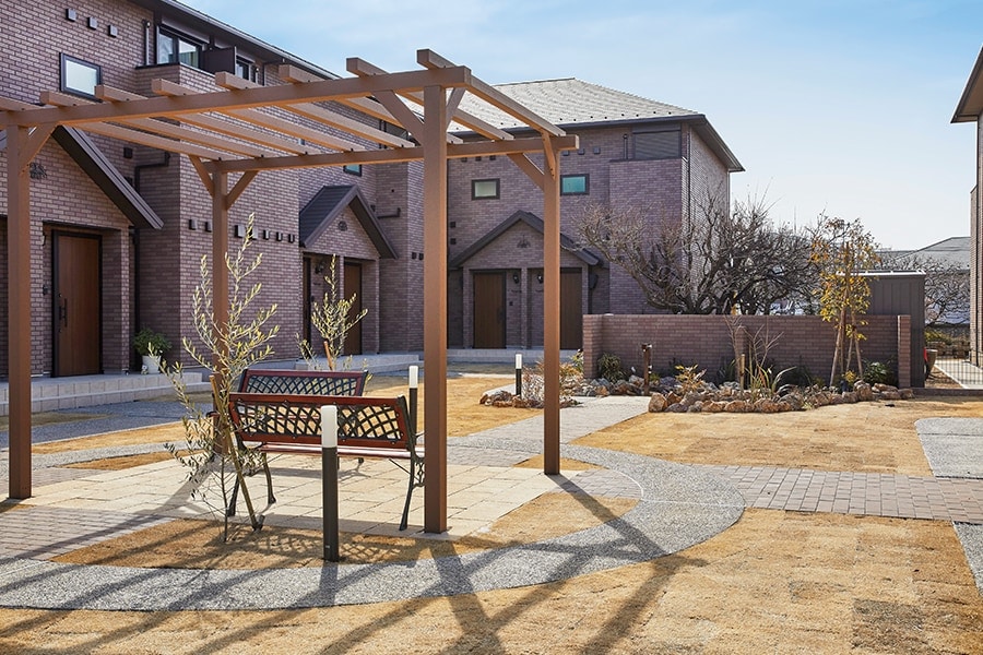 芝生と石畳が印象的なベンチのある中庭。住人同士の会話が弾むのが目に浮かびます